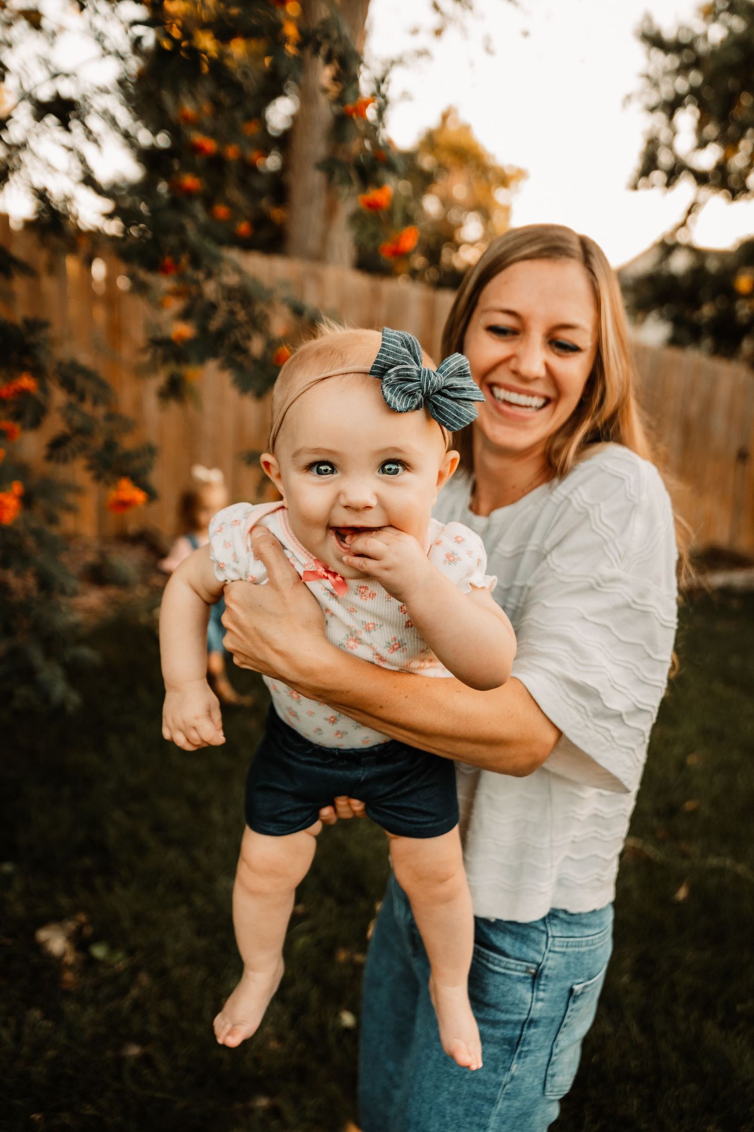 Mom lifting baby to the camera while smiling by Vine Photography in Salem Ohio