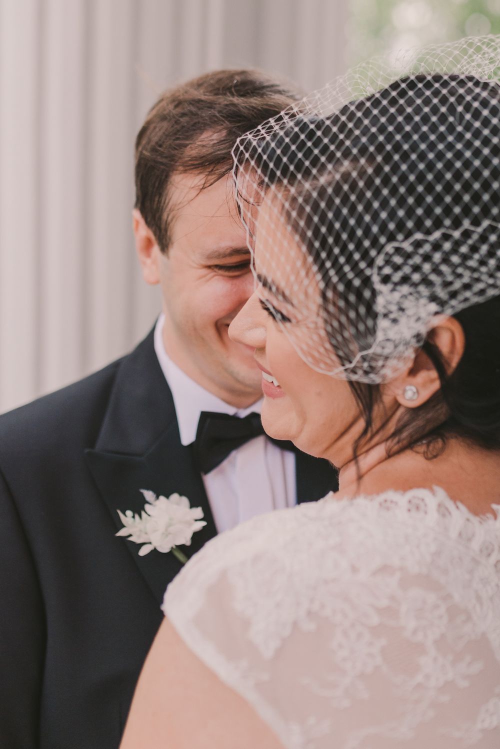 Intimate wedding portrait showing delicate lace details and tender expressions.