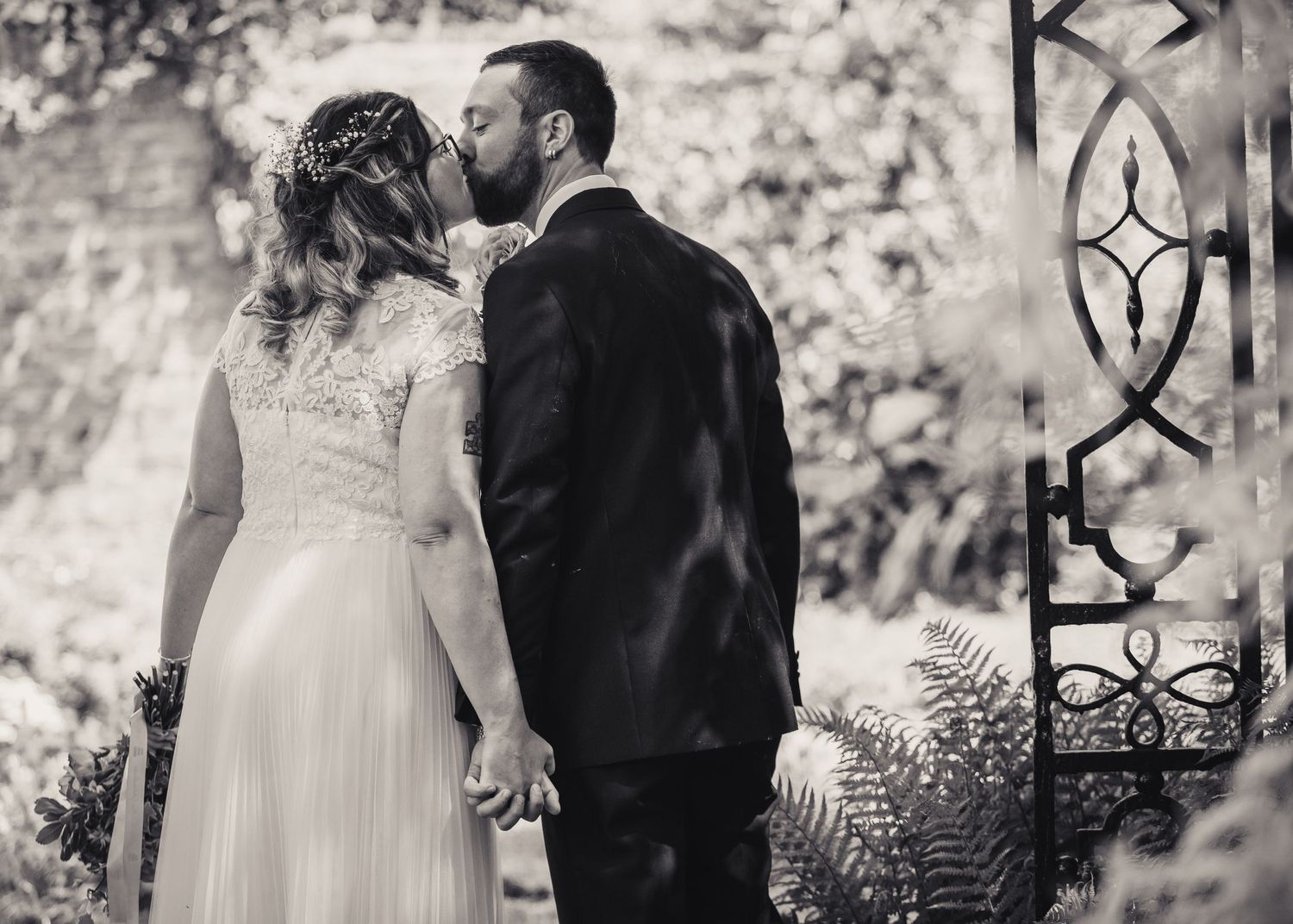 bride and groom back to camera kissing