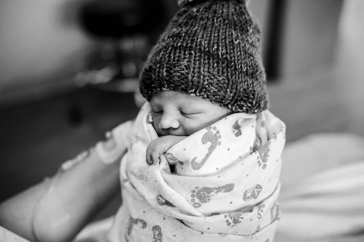 Newborn wearing the beautiful hand crocheted hat his mother had made him before birth.