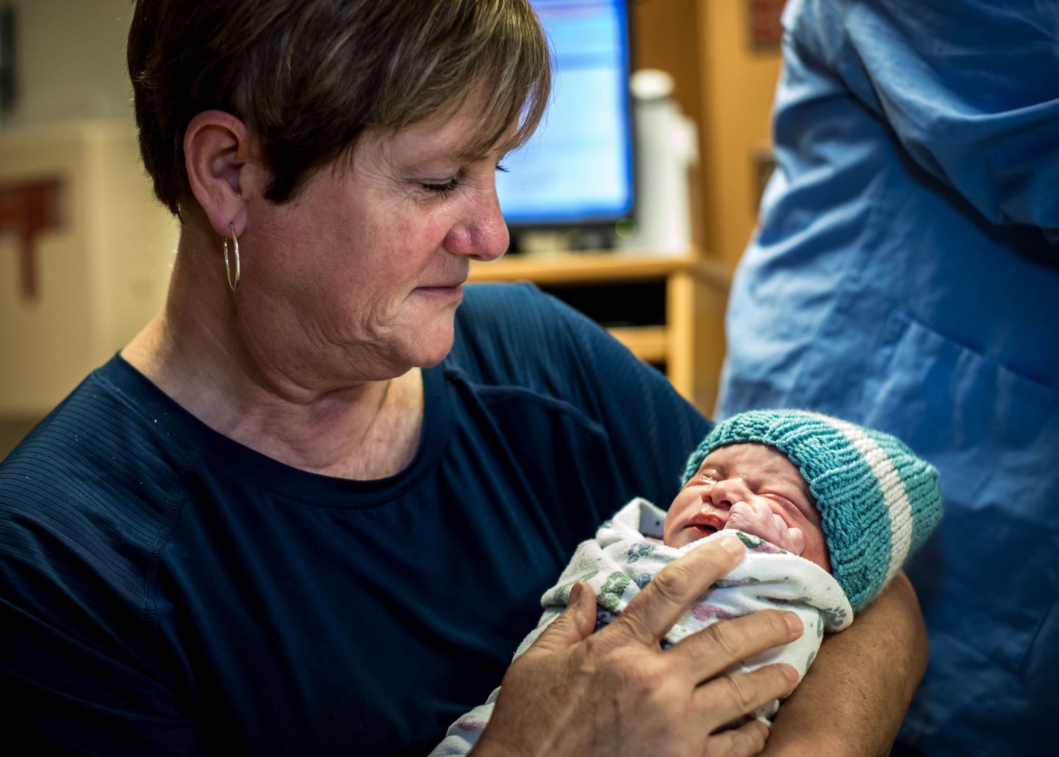 Grandmother holding her newest grandson just after birth.
