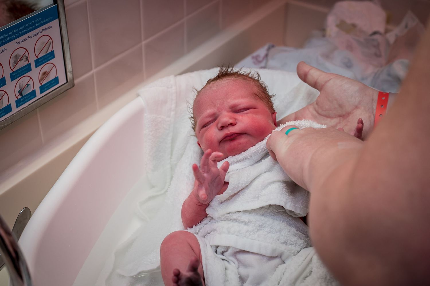 Newborn getting her first bath.