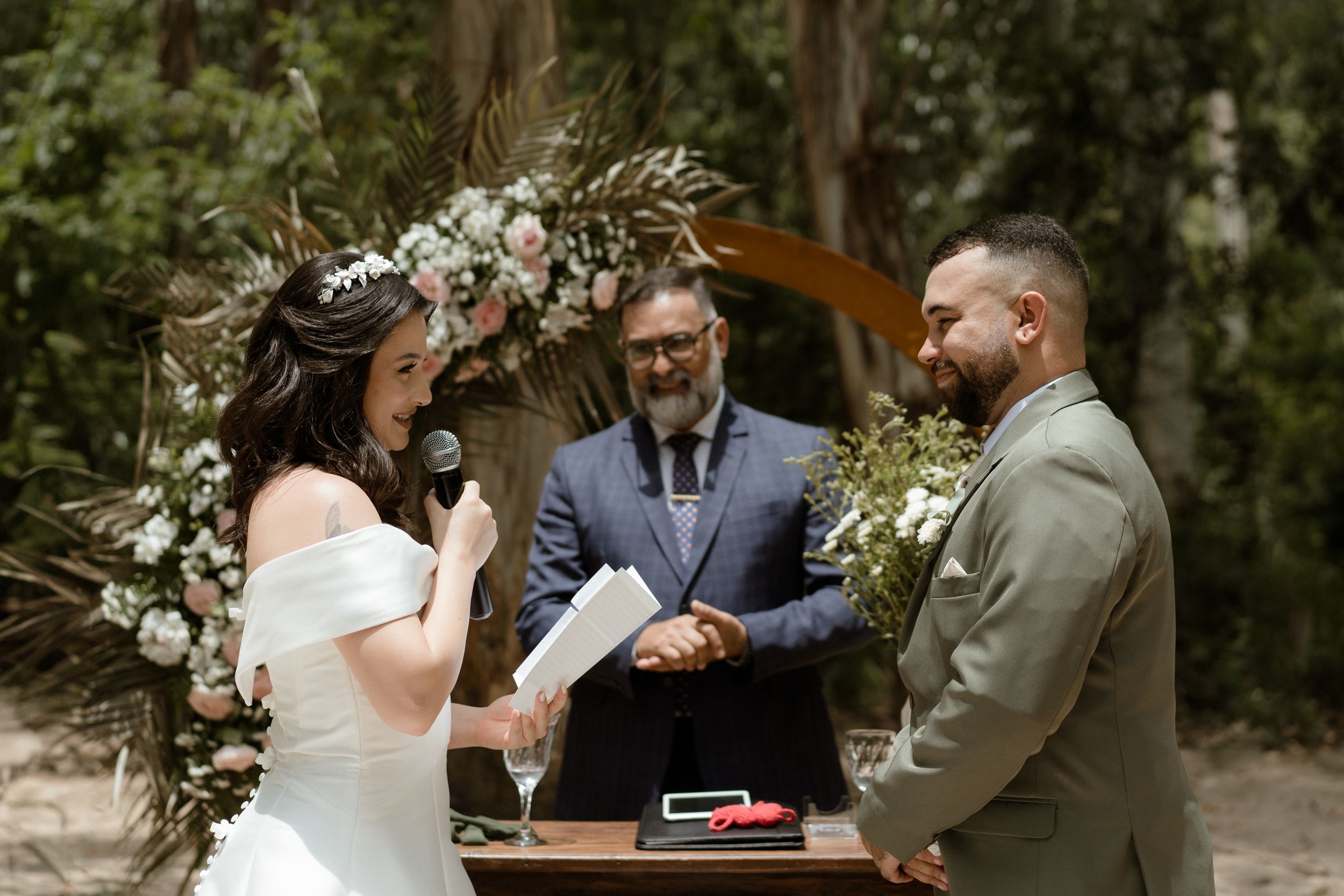 Emotional first look moment between a couple during their outdoor wedding ceremony in a wooded setting.