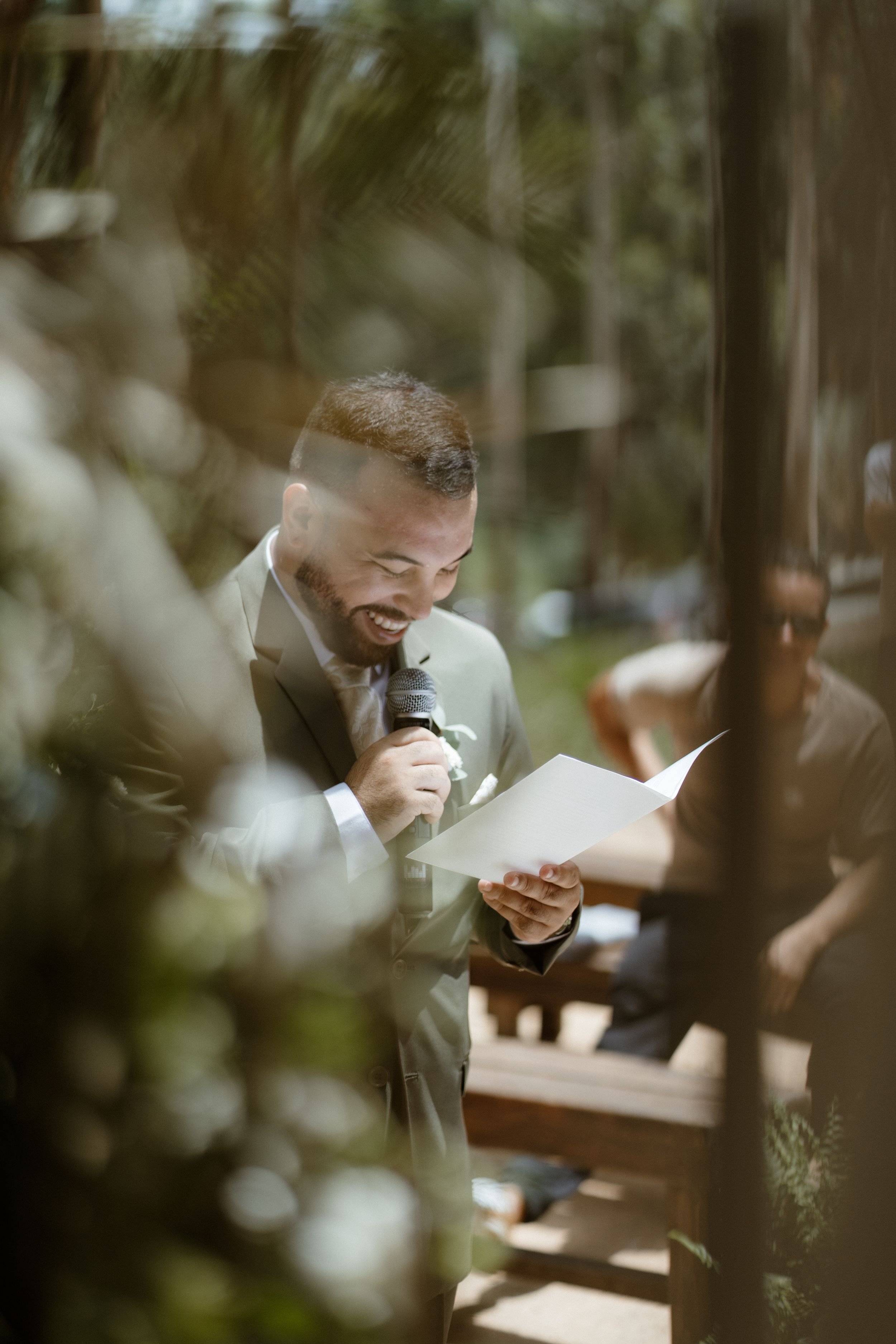Close-up of groom wiping tears during emotional wedding ceremony moment.
