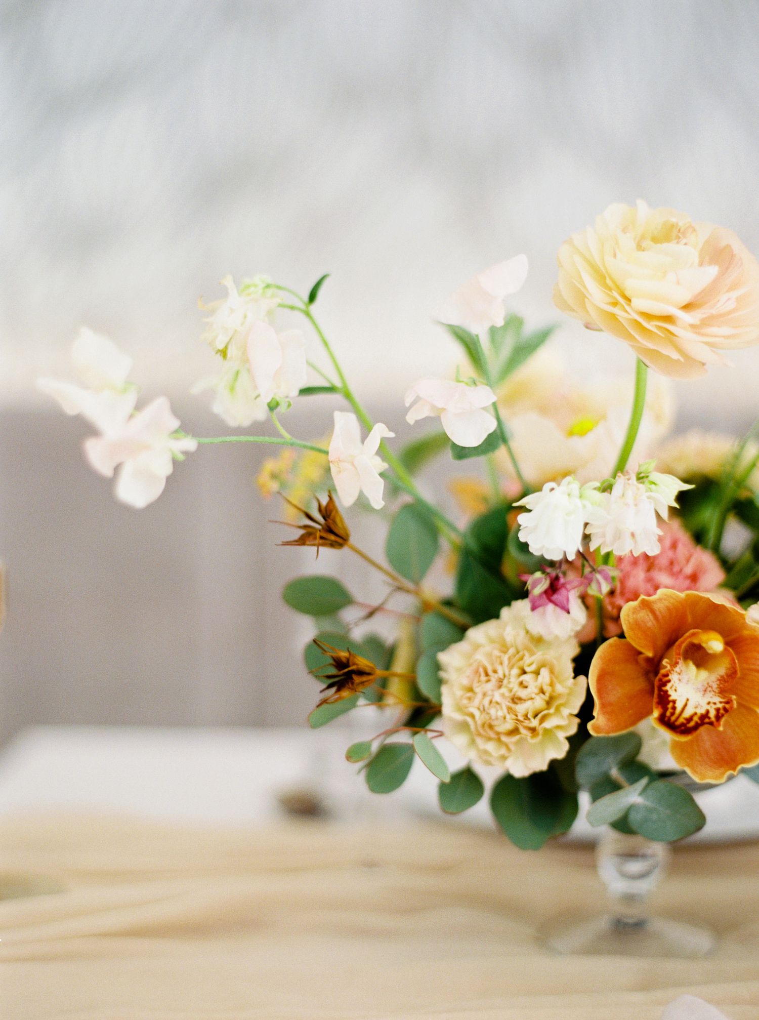 Floral arrangement in a vase on a table at a Prague wedding.