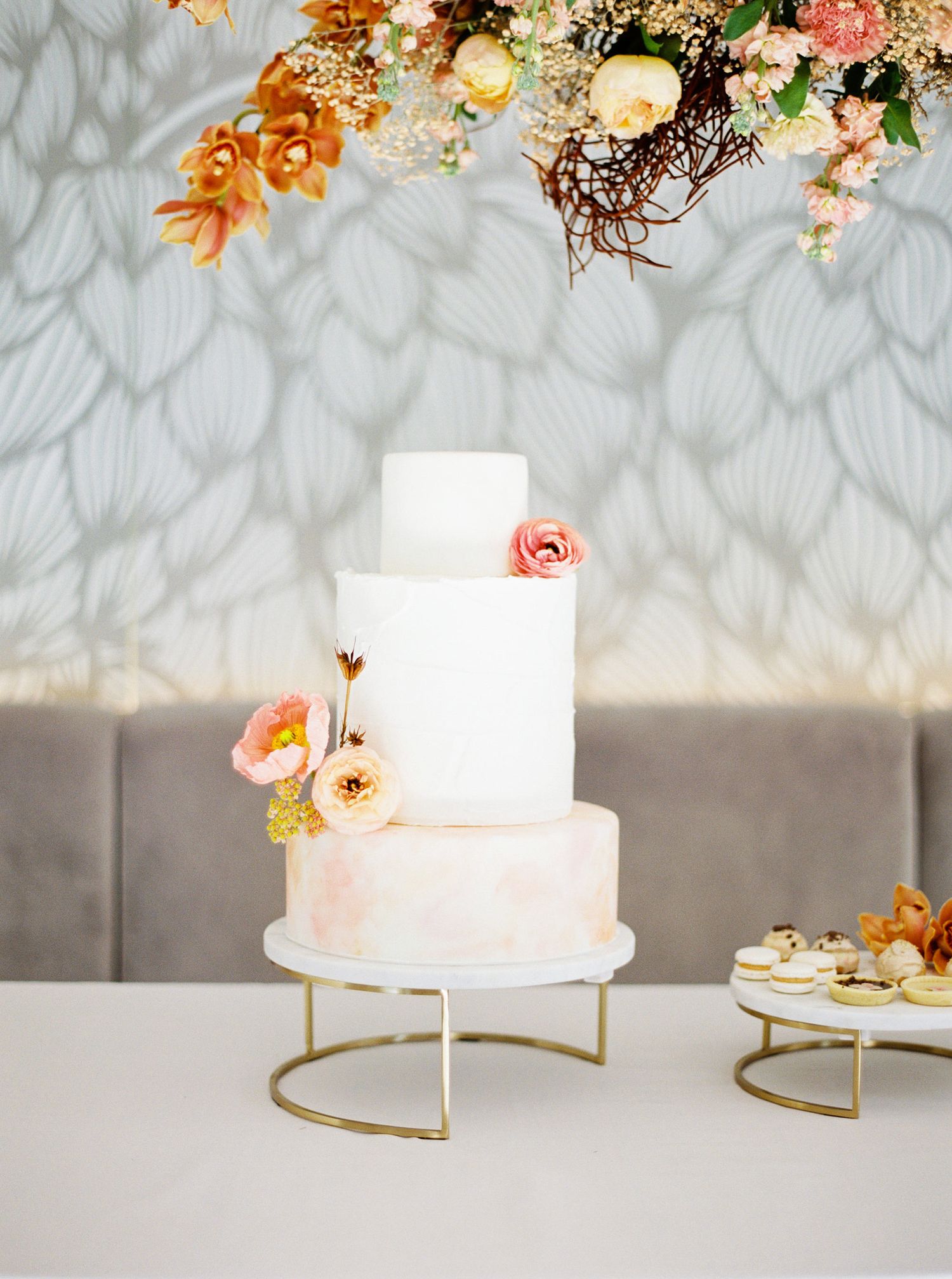 Elegant wedding cake adorned with flowers in Prague.