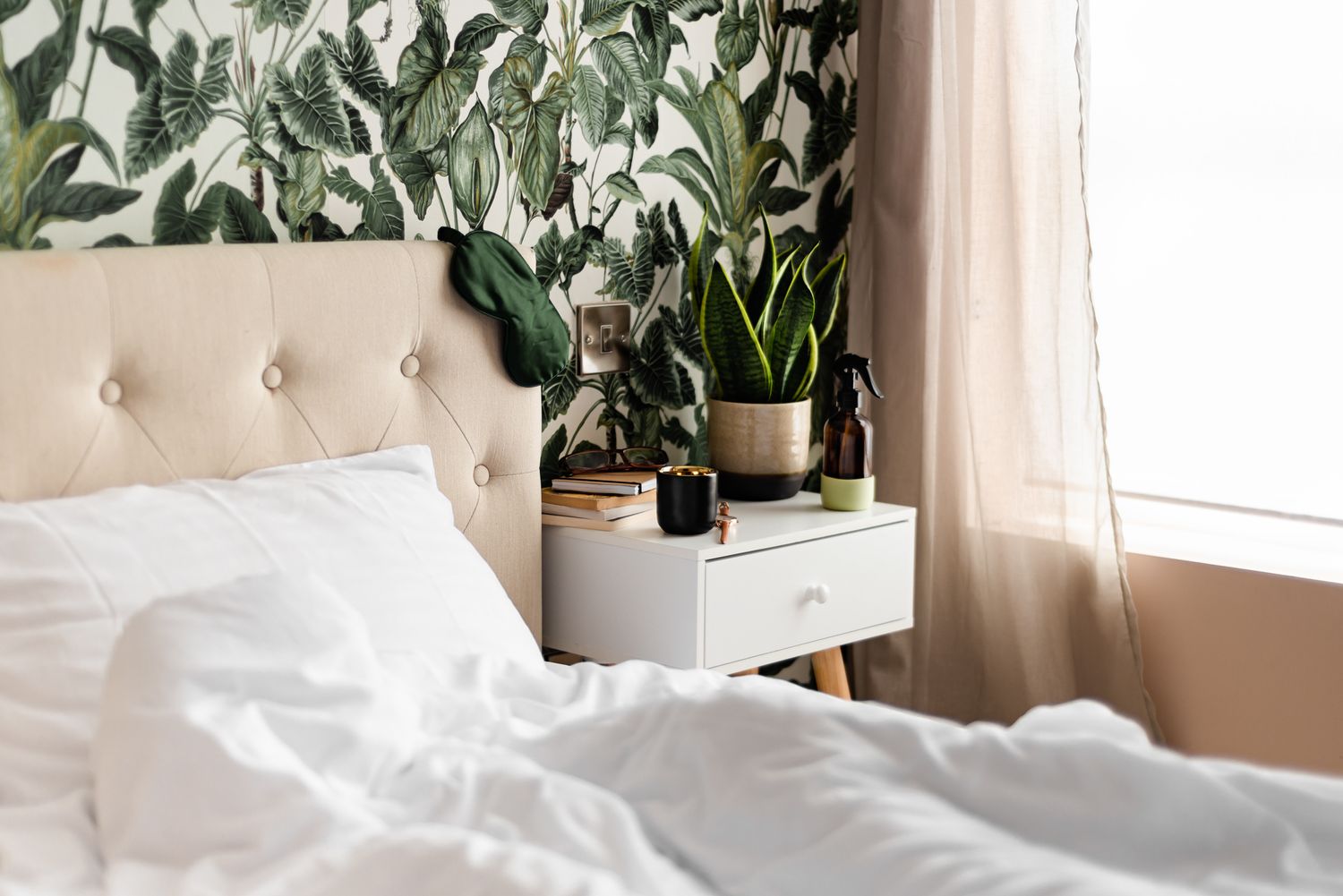 cozy bedroom with botanical wallpaper and plants on bedside table, holiday lets, airbnb,