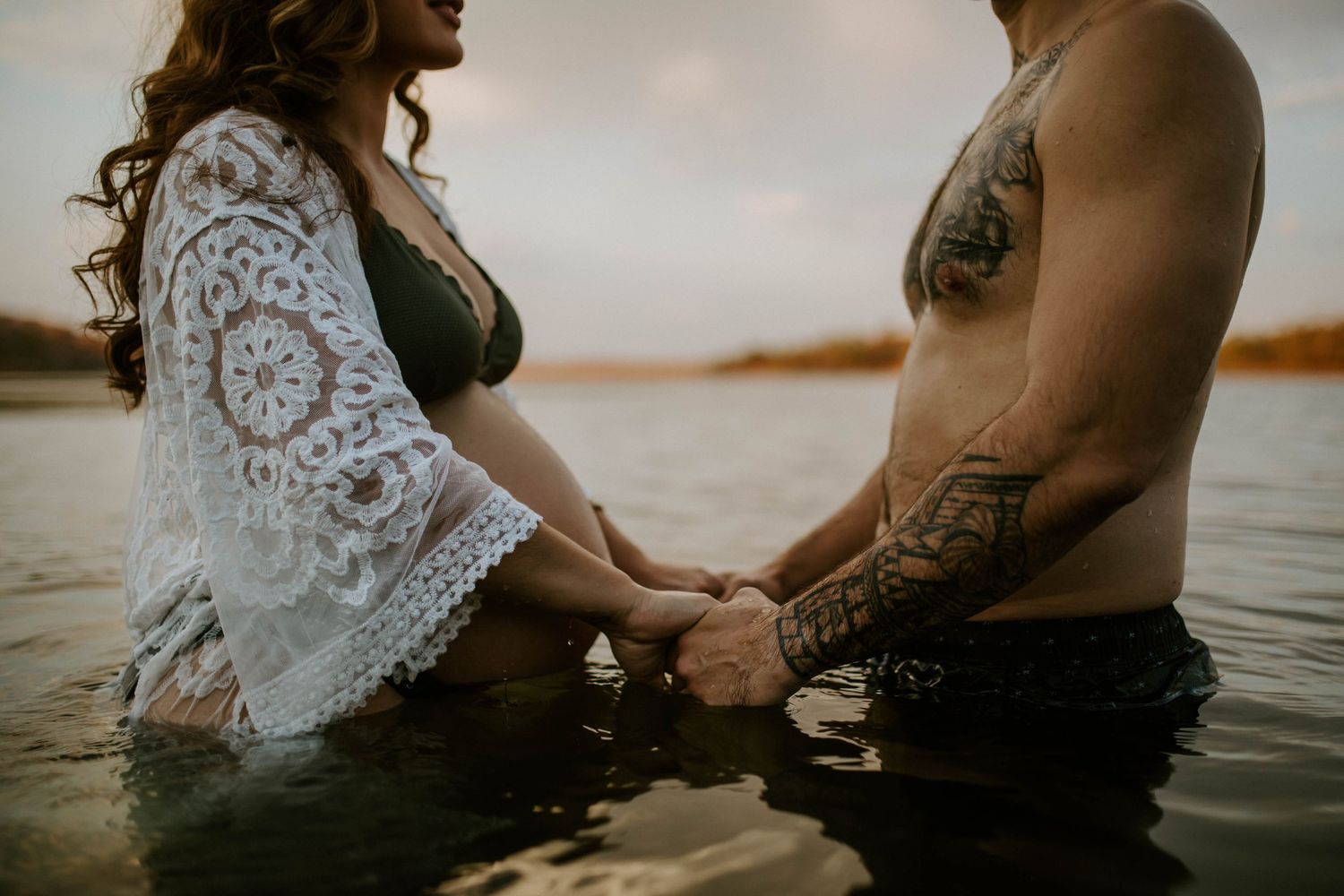 Couple holding hands in the waters of Lake Moondarra Mount Isa