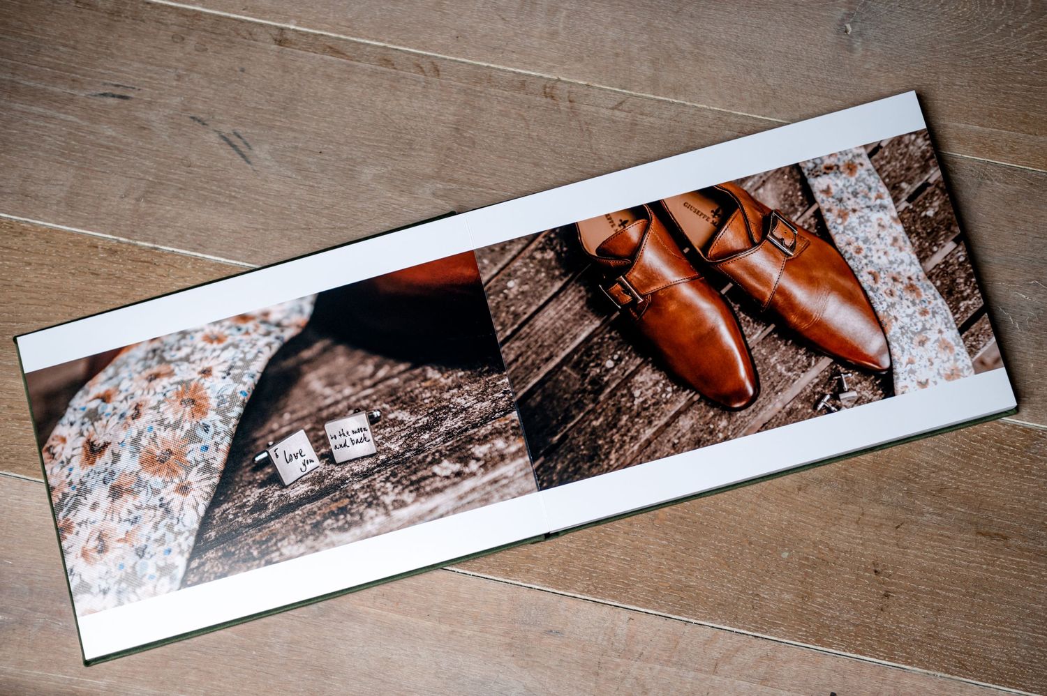 Artistic arrangement of photo prints laid out on a wooden table surface.