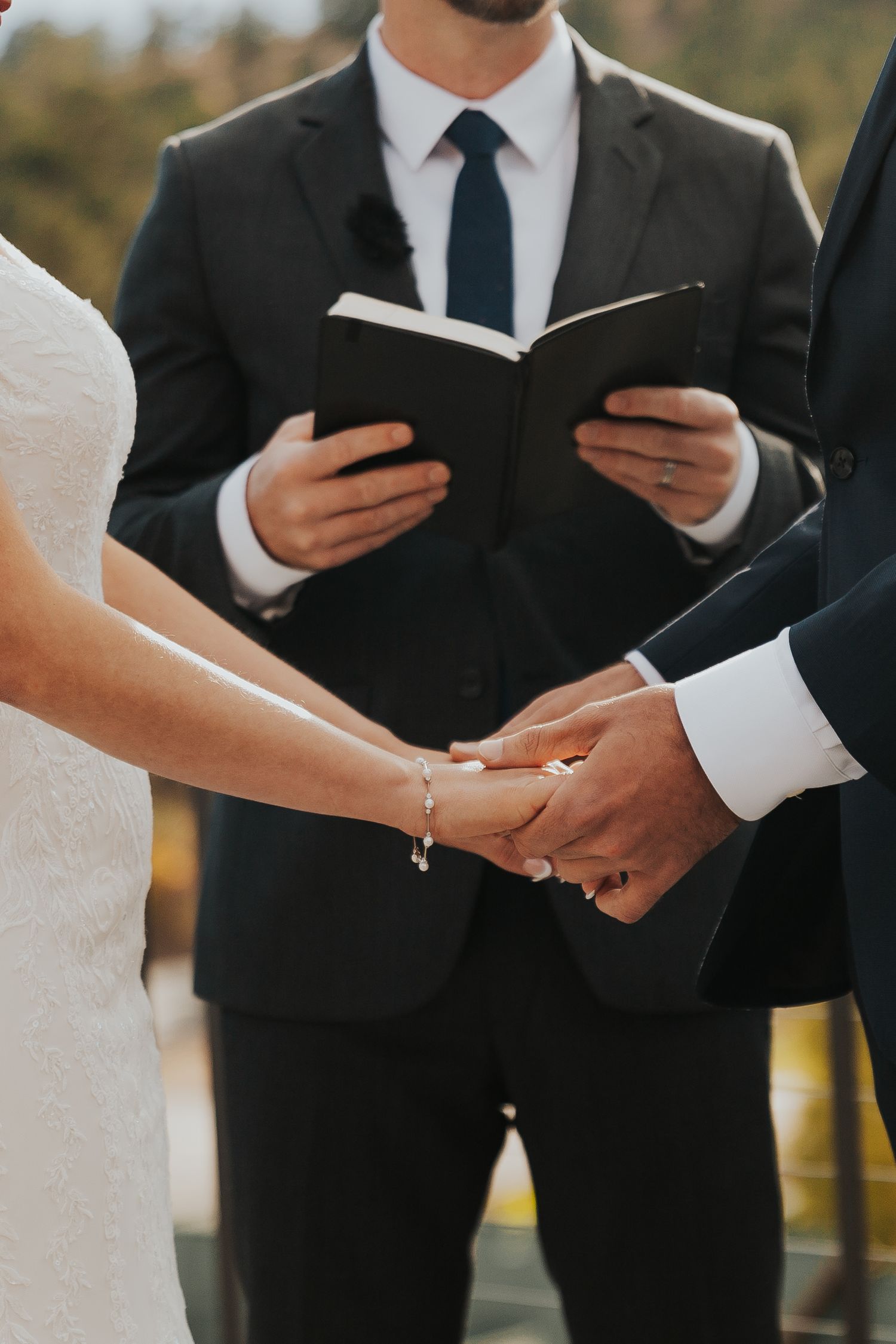 Bride and groom holding hands at ceremony