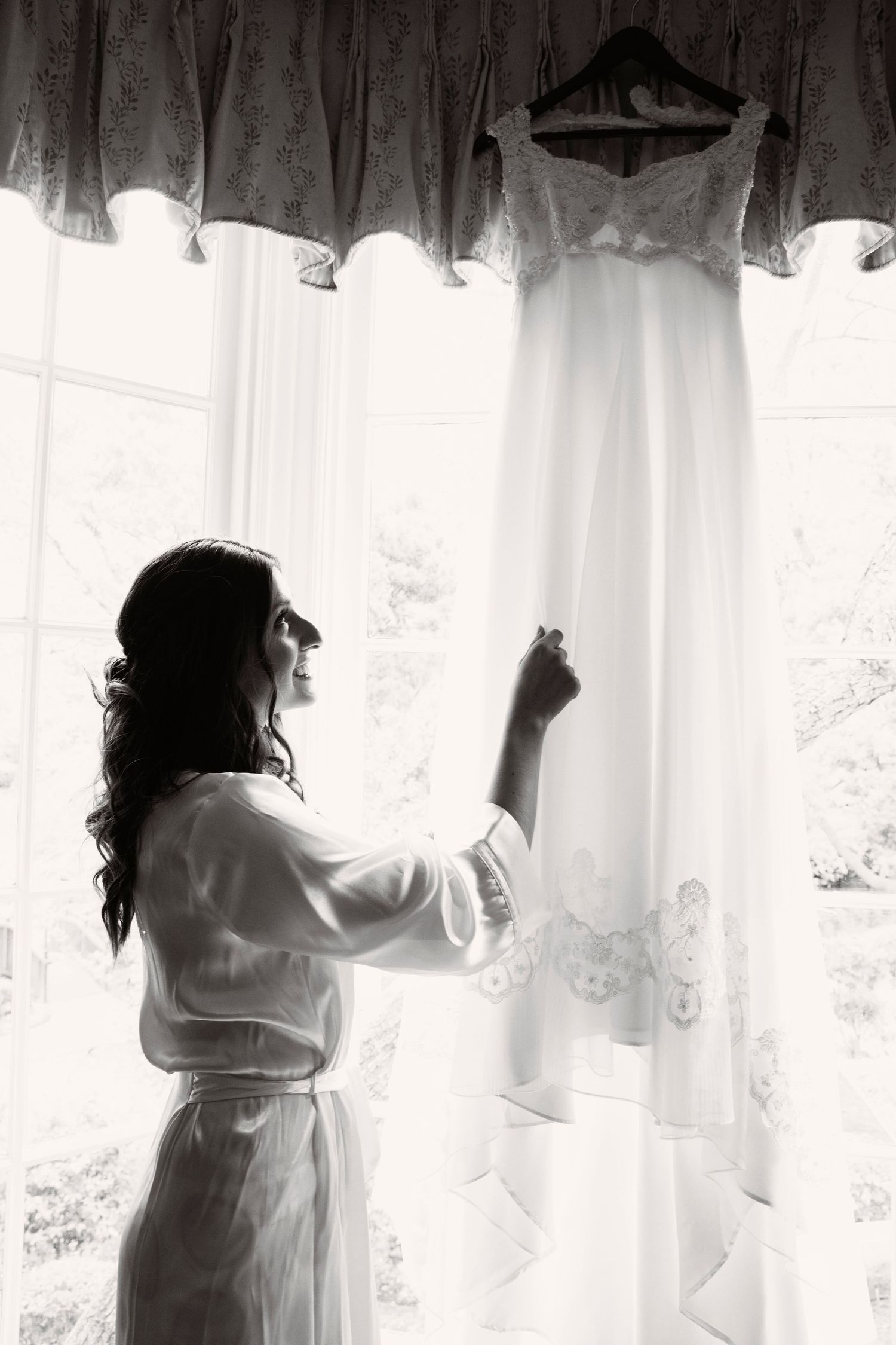 Wedding Dress; Bride looking at the Wedding Dress. Wedding Photographer