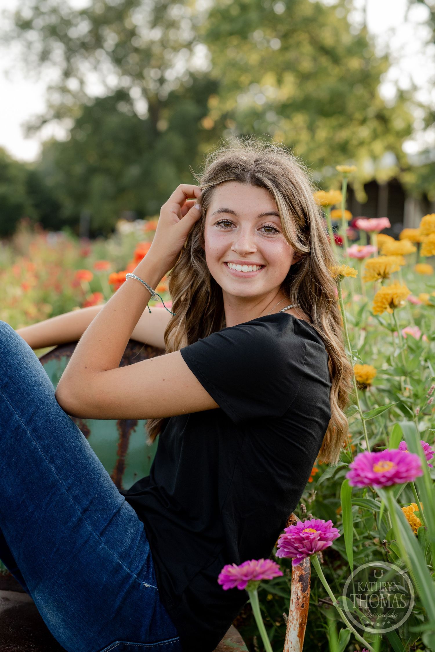 Portrait in a flower garden with colorful zinnias and natural lighting at golden hour.