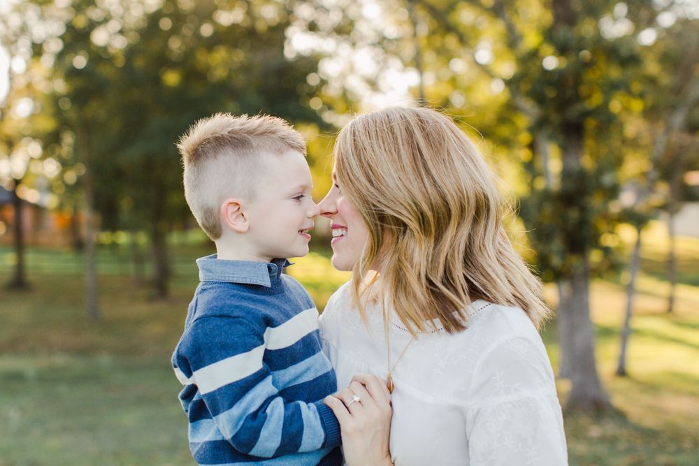 An intimate moment between parent and child captured in soft natural lighting.
