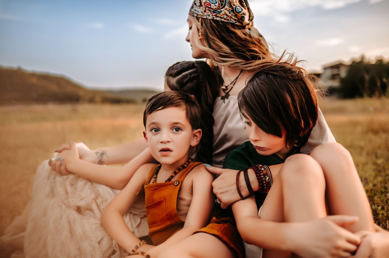 Intimate family moment captured during outdoor sunset photo session.