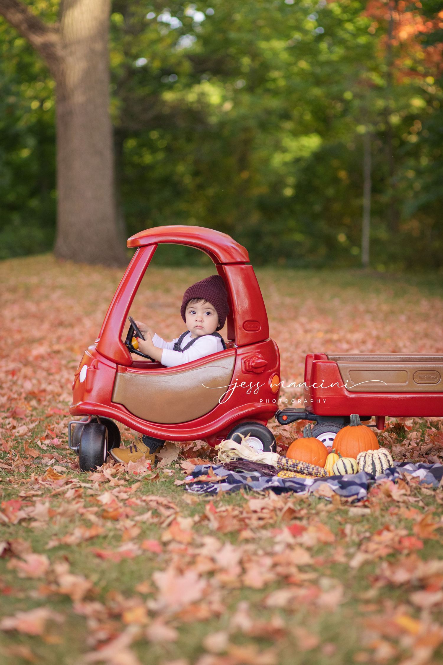 jess Mancini photography little tikes cozy couple makeover truck fall photoshoot leaves and pumpkins little kid driving