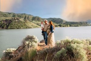 Family portrait session in mountain landscape during sunset.