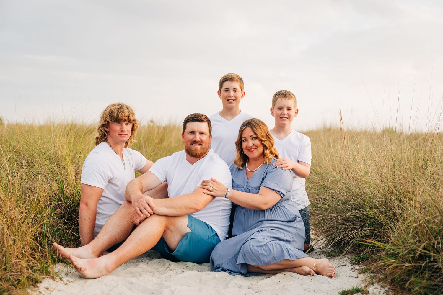 Family of boys posing together on Siesta Key Beach, During Family Photos. Family Beach Photographer Samantha Brown.