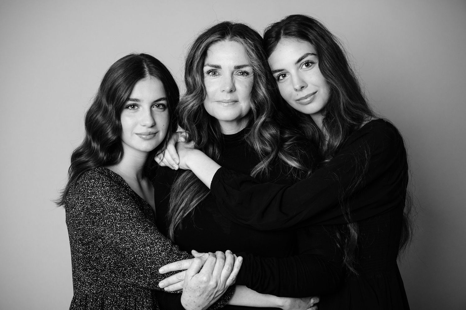 Black and white studio portraits capturing three people in an artistic group pose.