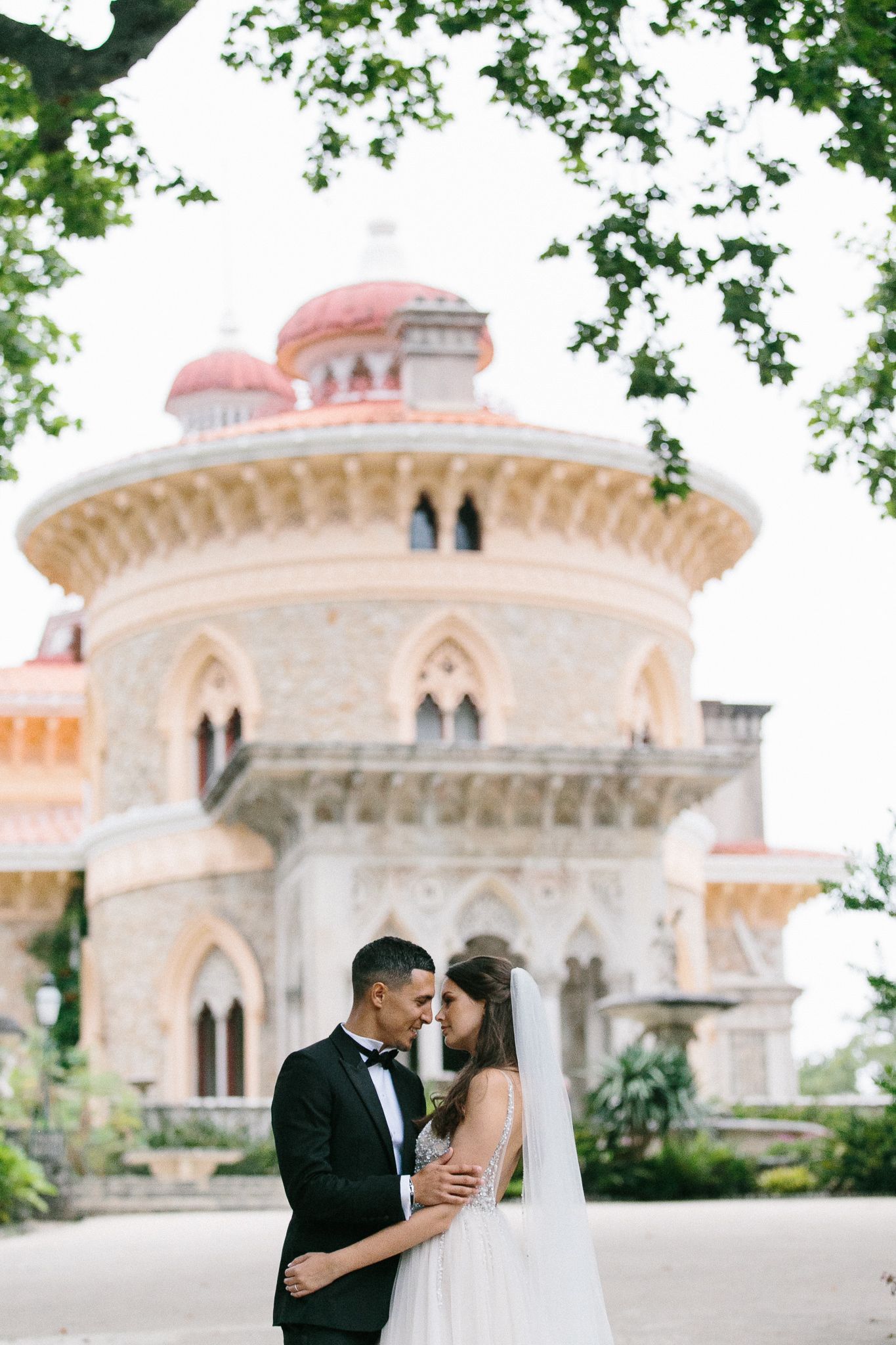 Romantic wedding portrait in front of Monserrate Palace with pink domes.