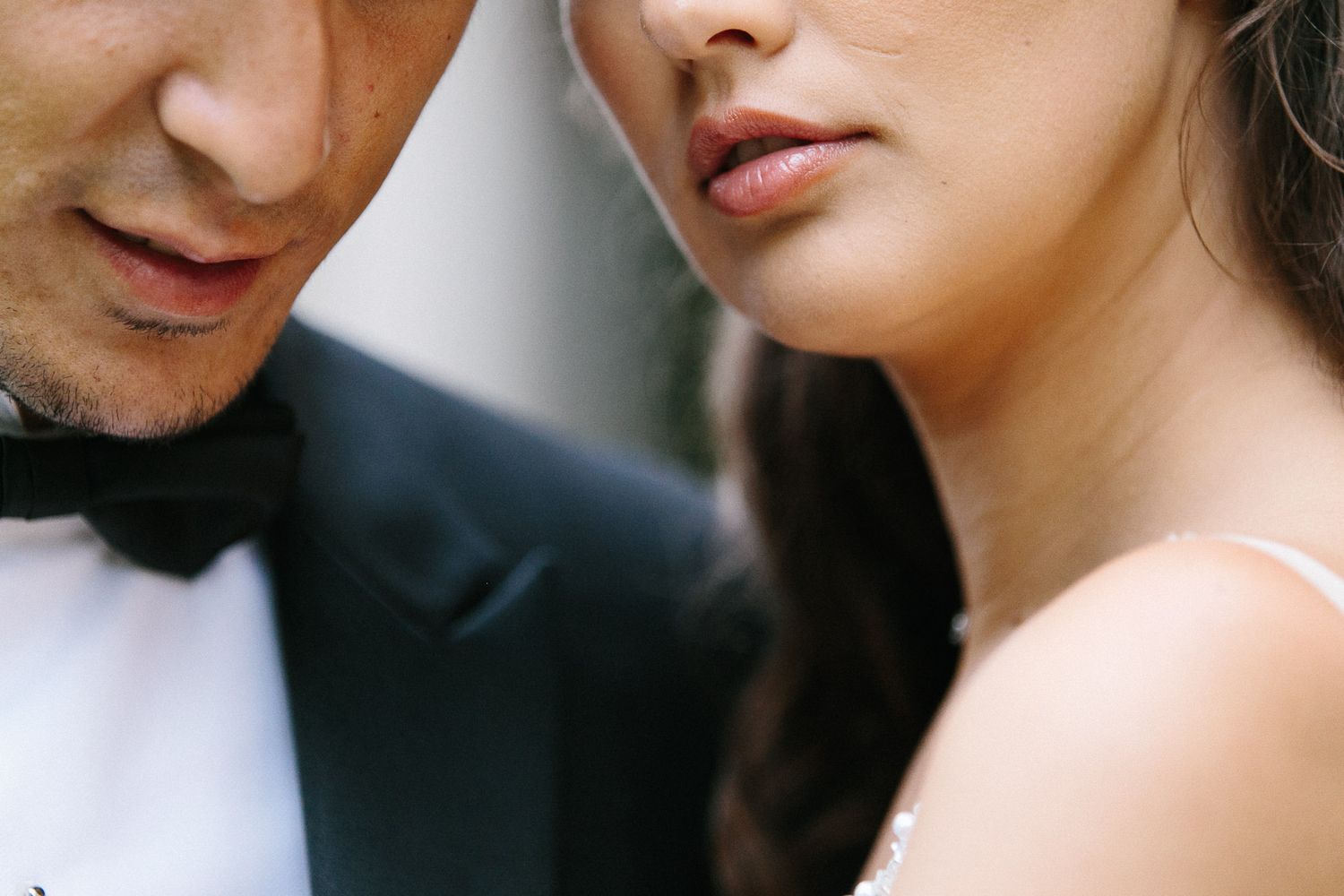 Artistic macro shot of couple in formal wear with selective focus.
