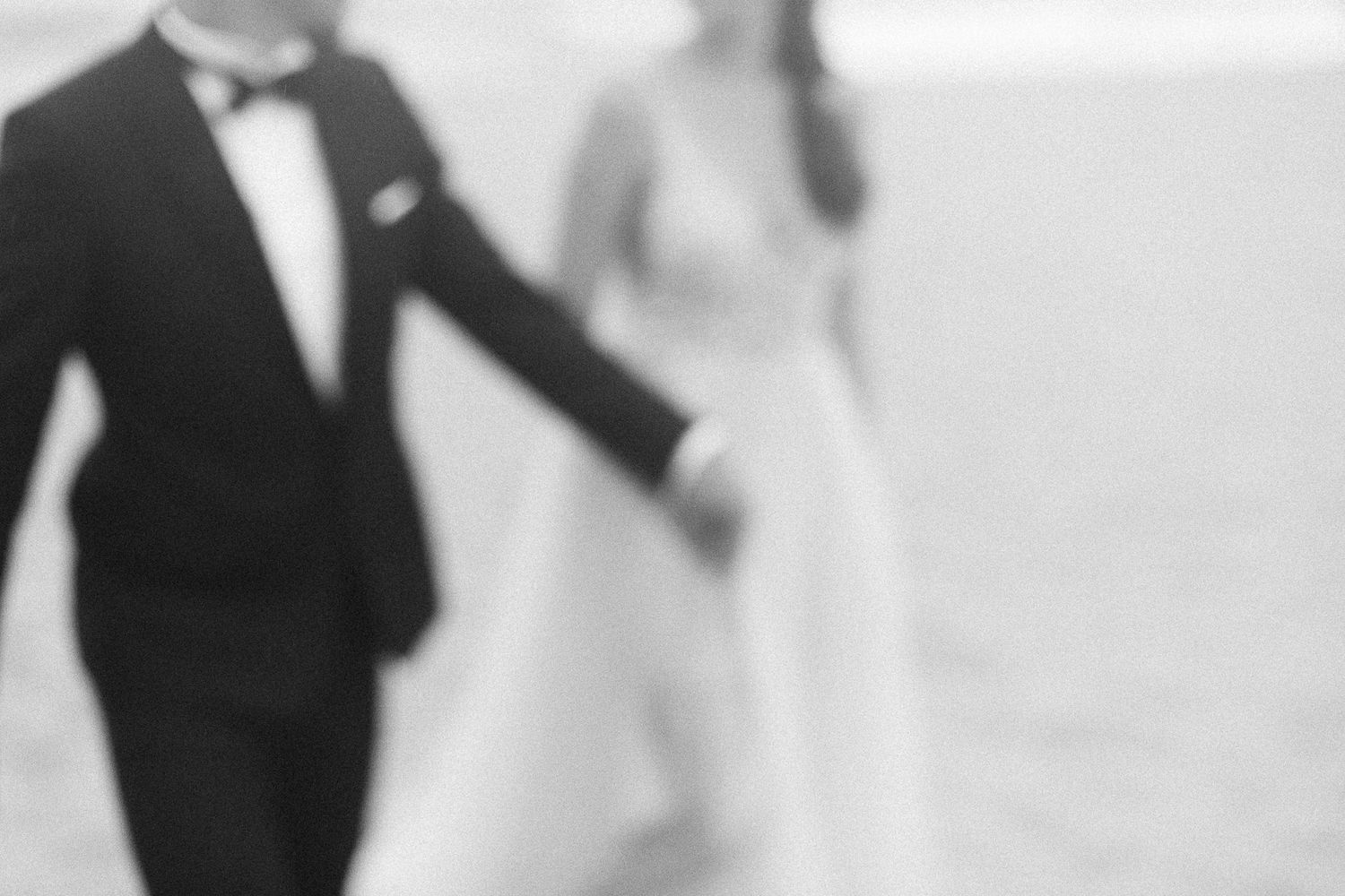 Blurred artistic wedding photo showing silhouettes of couple in motion.