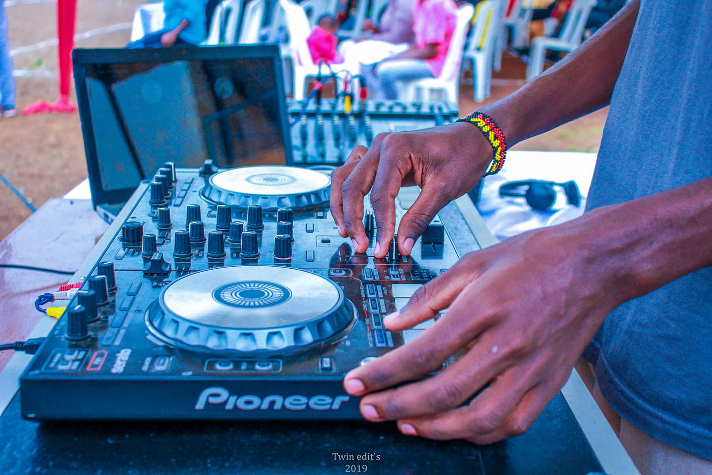 a deejay operating a pioneer deejay controler/ player at an event photography