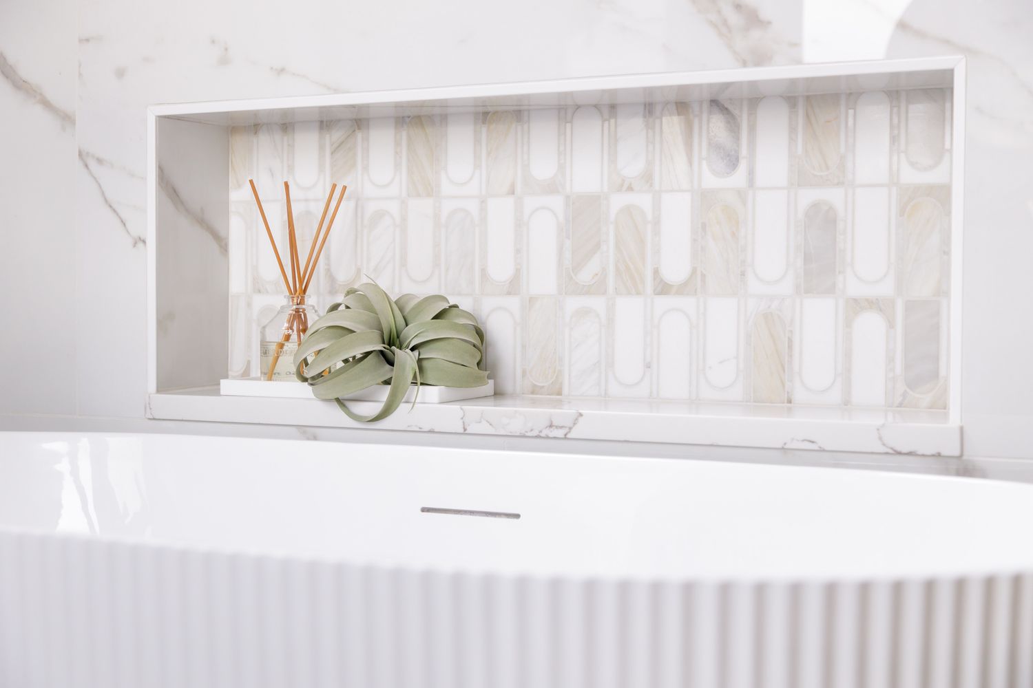 H. Bero Interior Design photos detail of bathroom tile and textured tub with plant in Orting, WA