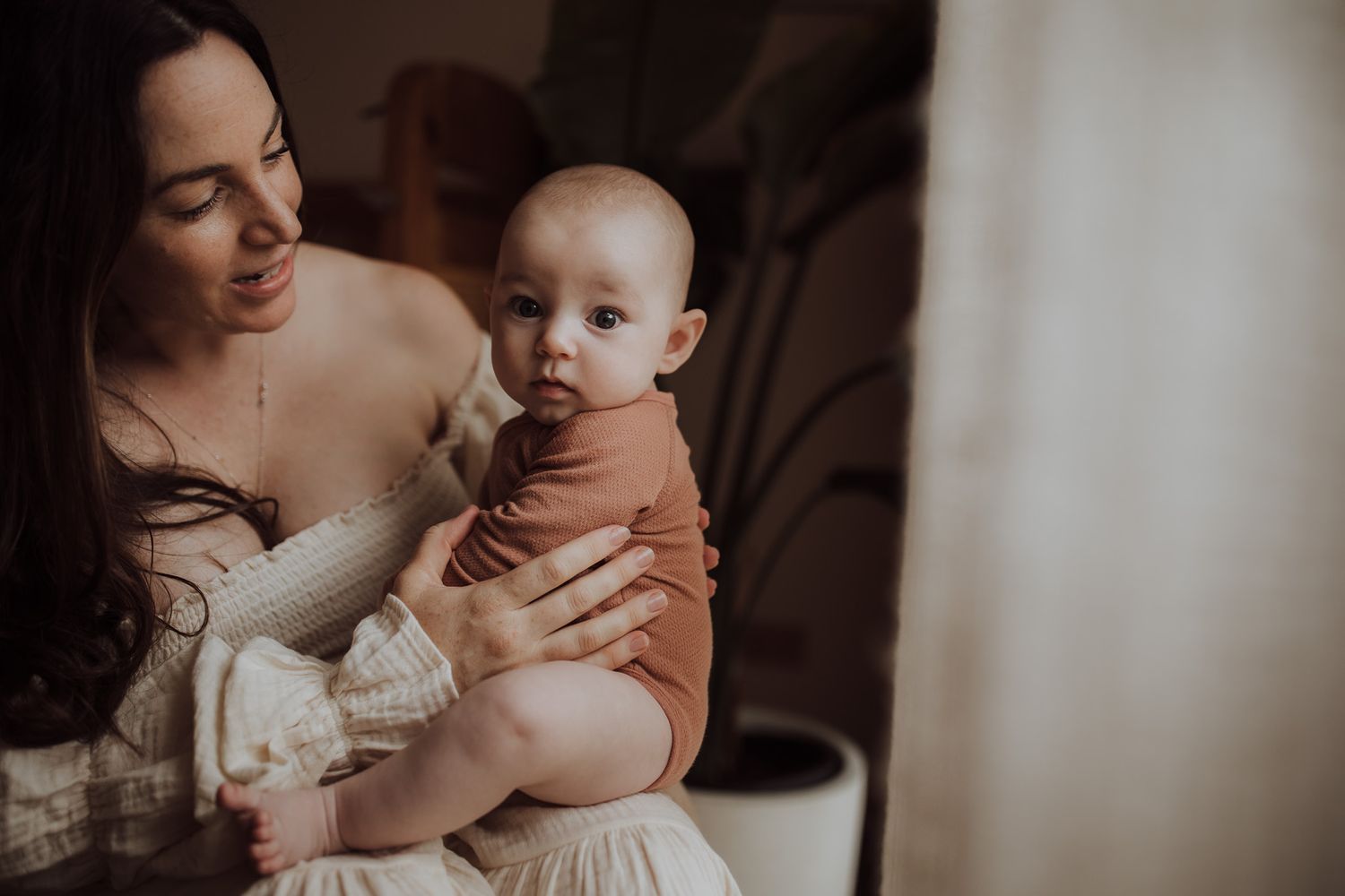 Intimate indoor portrait with soft lighting and delicate lace details.