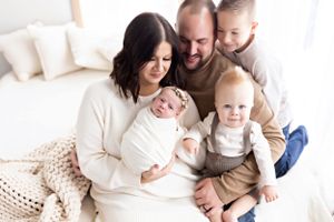 Modern family portrait session in cream and neutral tones with natural styling.