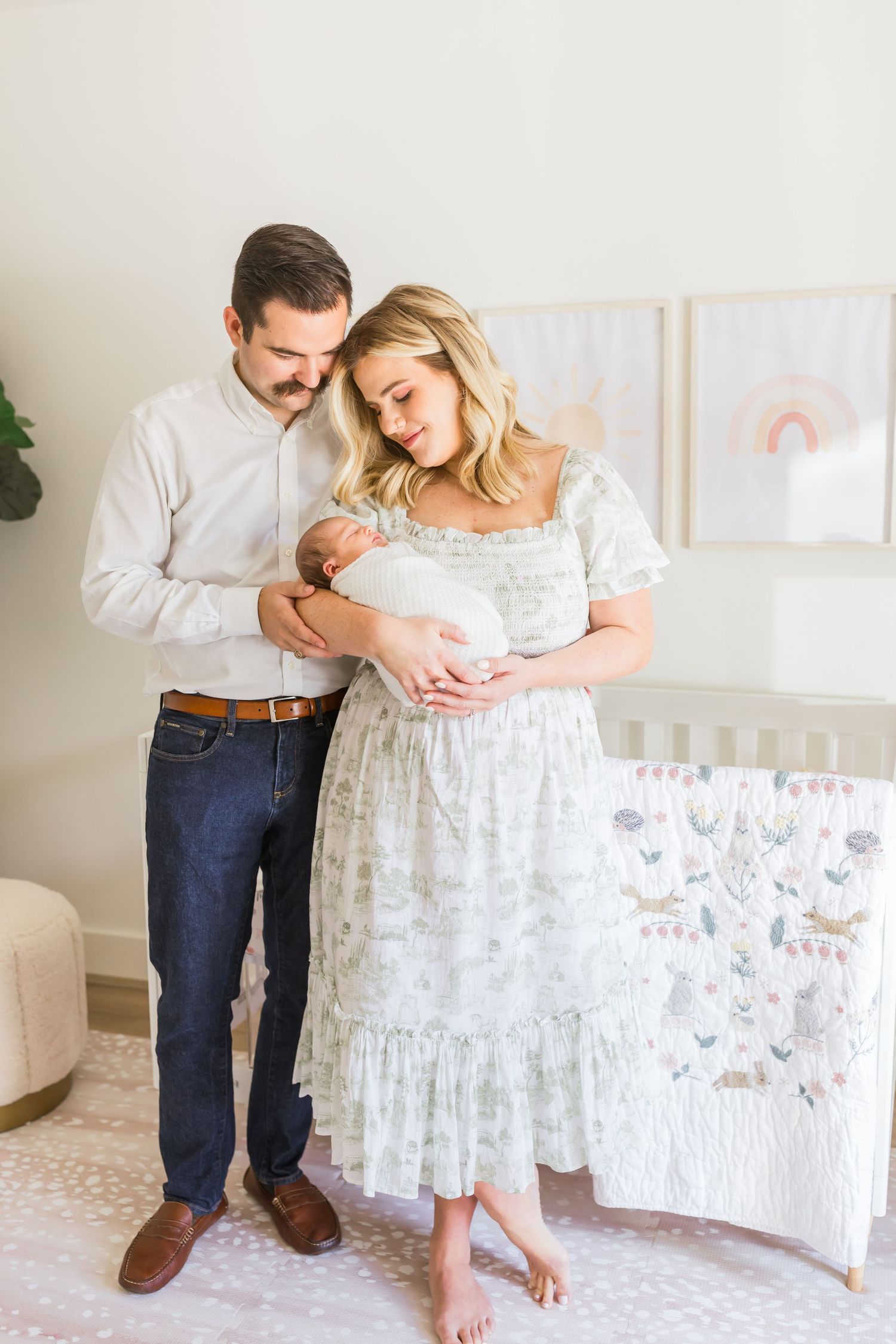 A tender moment in a peaceful nursery decorated with pastel artwork and floral bedding.