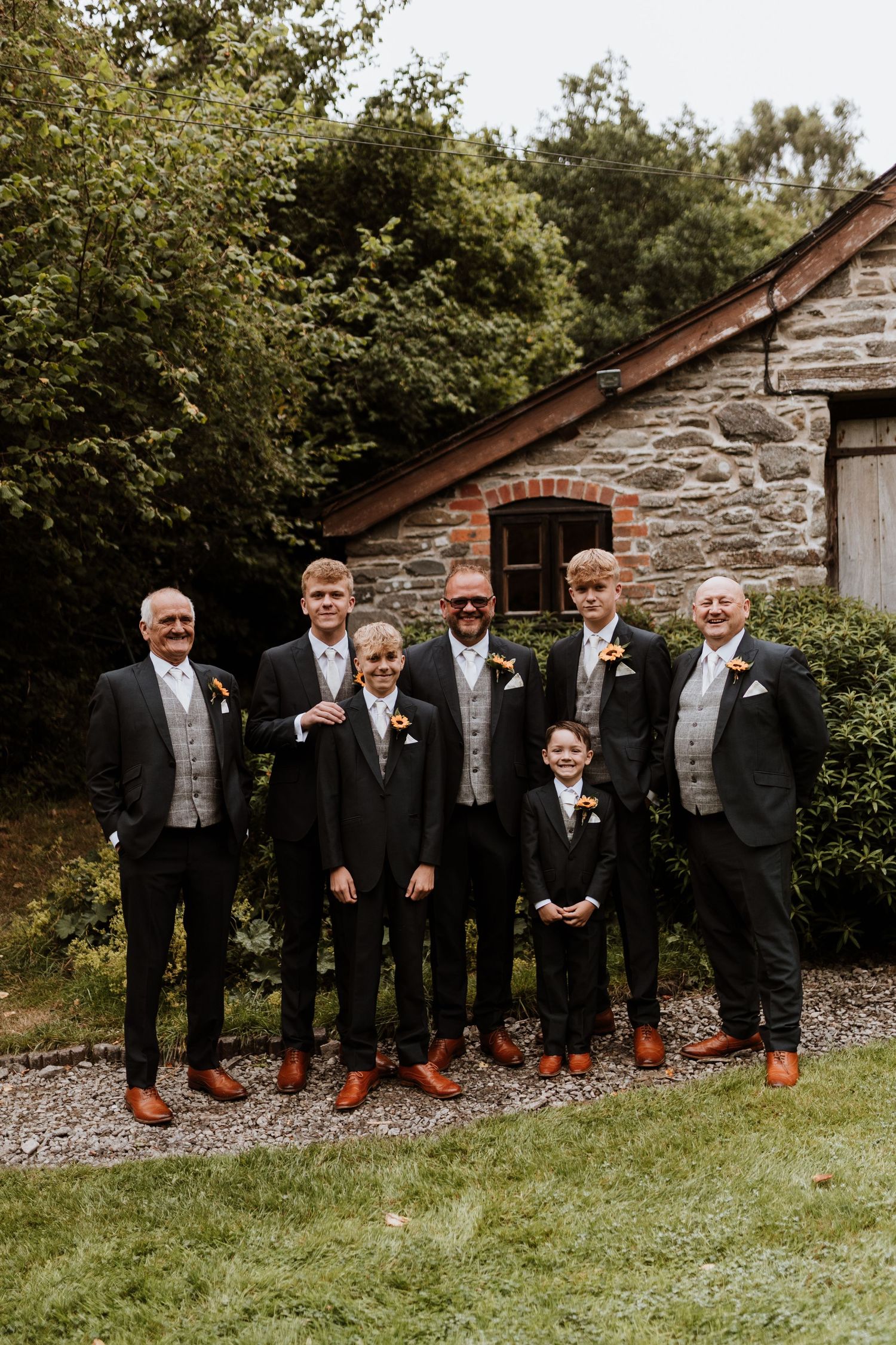 Groom and groomsmen hanging out before ceremony at Glyngynwydd Wedding Barns, Llanidloes