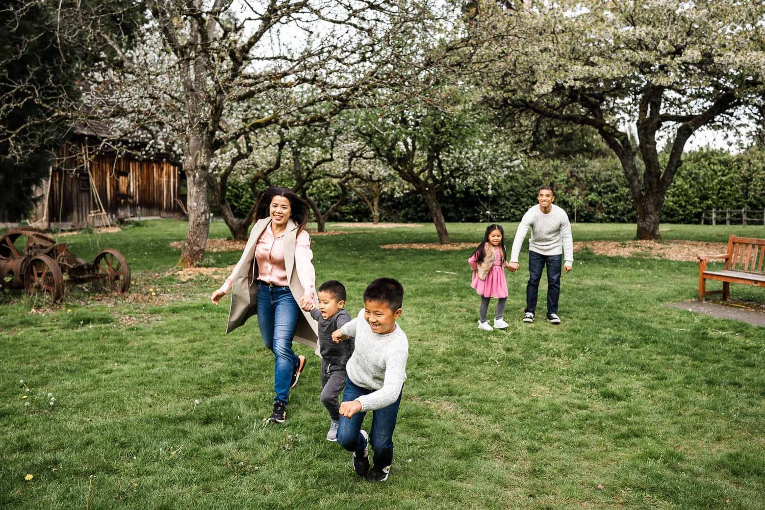 Photographer capturing candid moment of family running and laughing