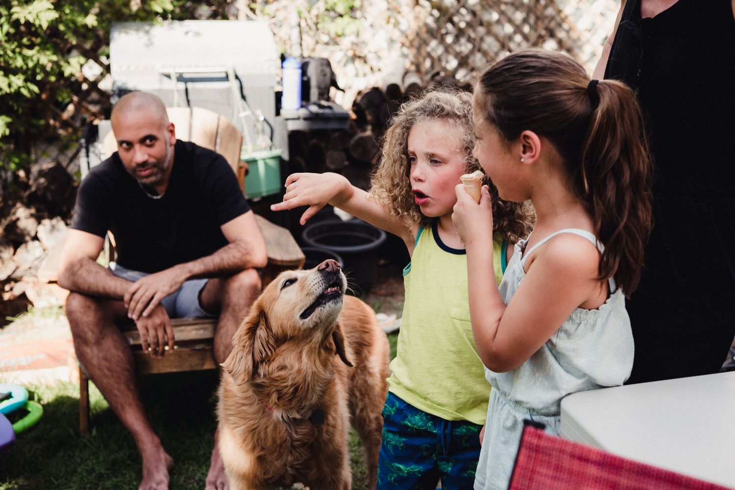 A young boy points toward something, his dog looks on.