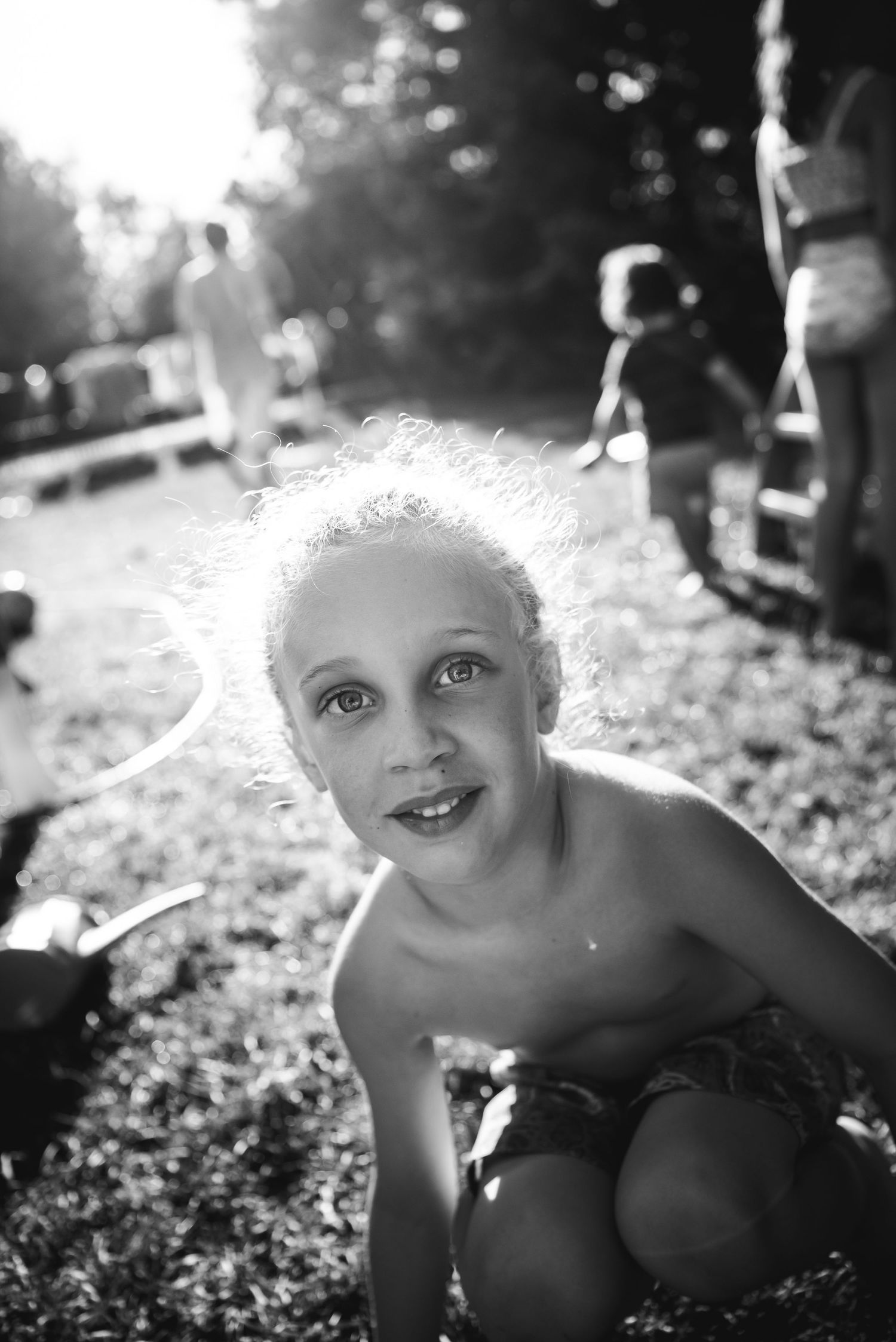 BW image of a young blond boy backlit by the afternoon summer sun.