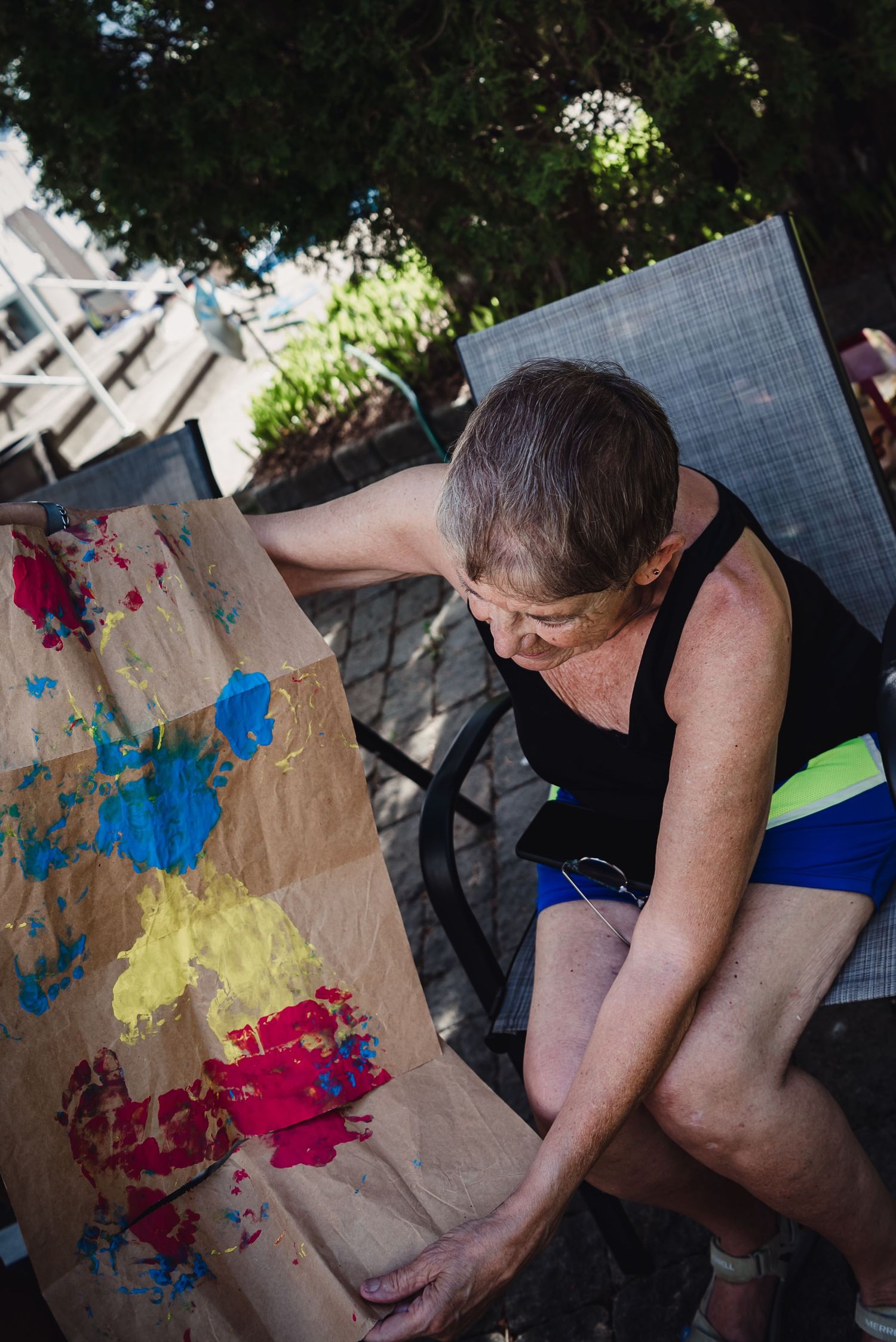 A woman looks at the colourful artwork that her granddaughter made for her.