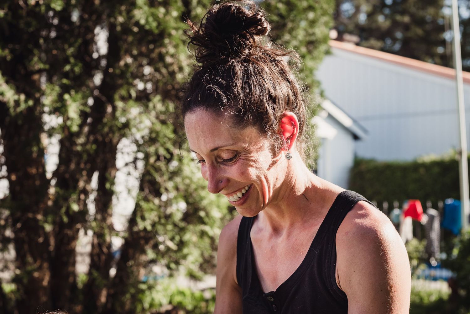 A woman looks down smiling.