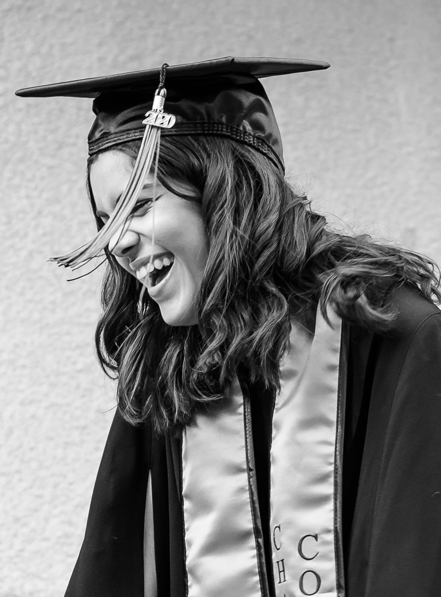 Girl in her graduation sash giggling