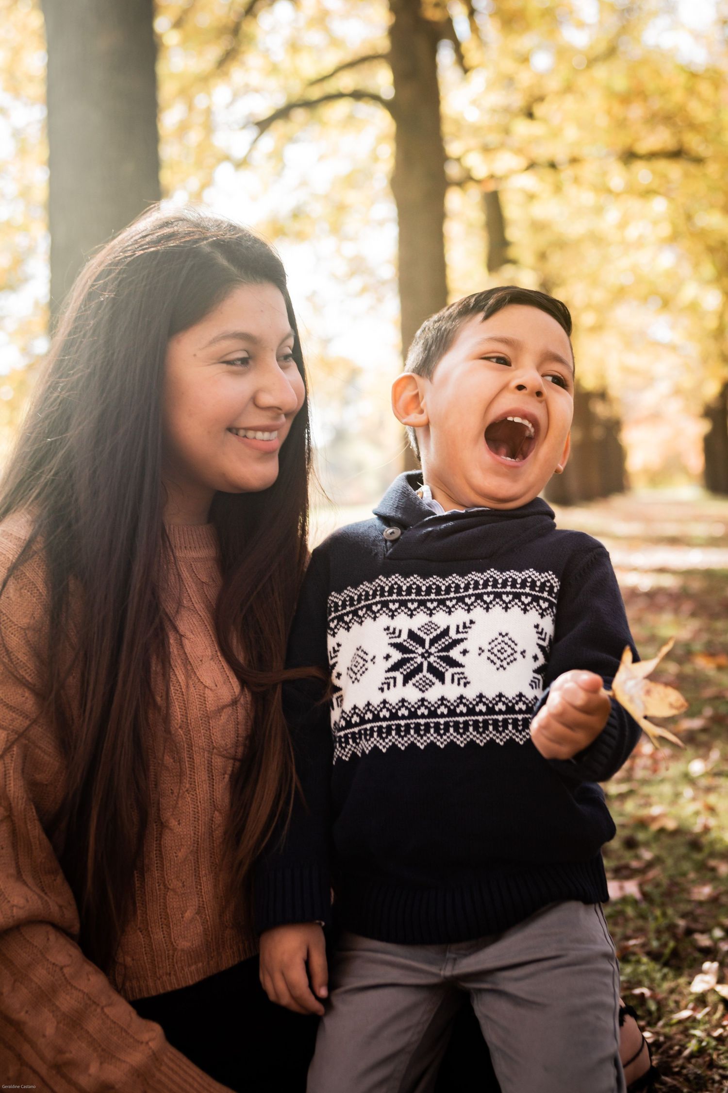 mom and son laughing of joy in the fall