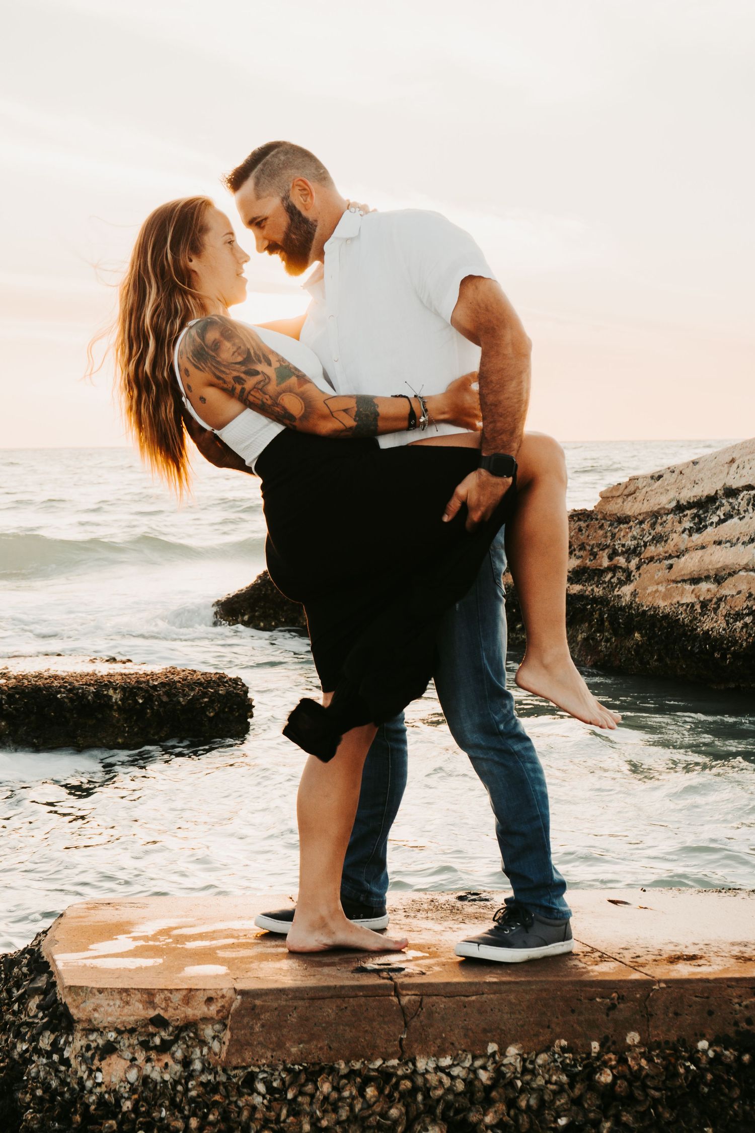 Outdoor Engagement Session Ft. Desoto, St. Pete, FL; Couple embracing at sunset
