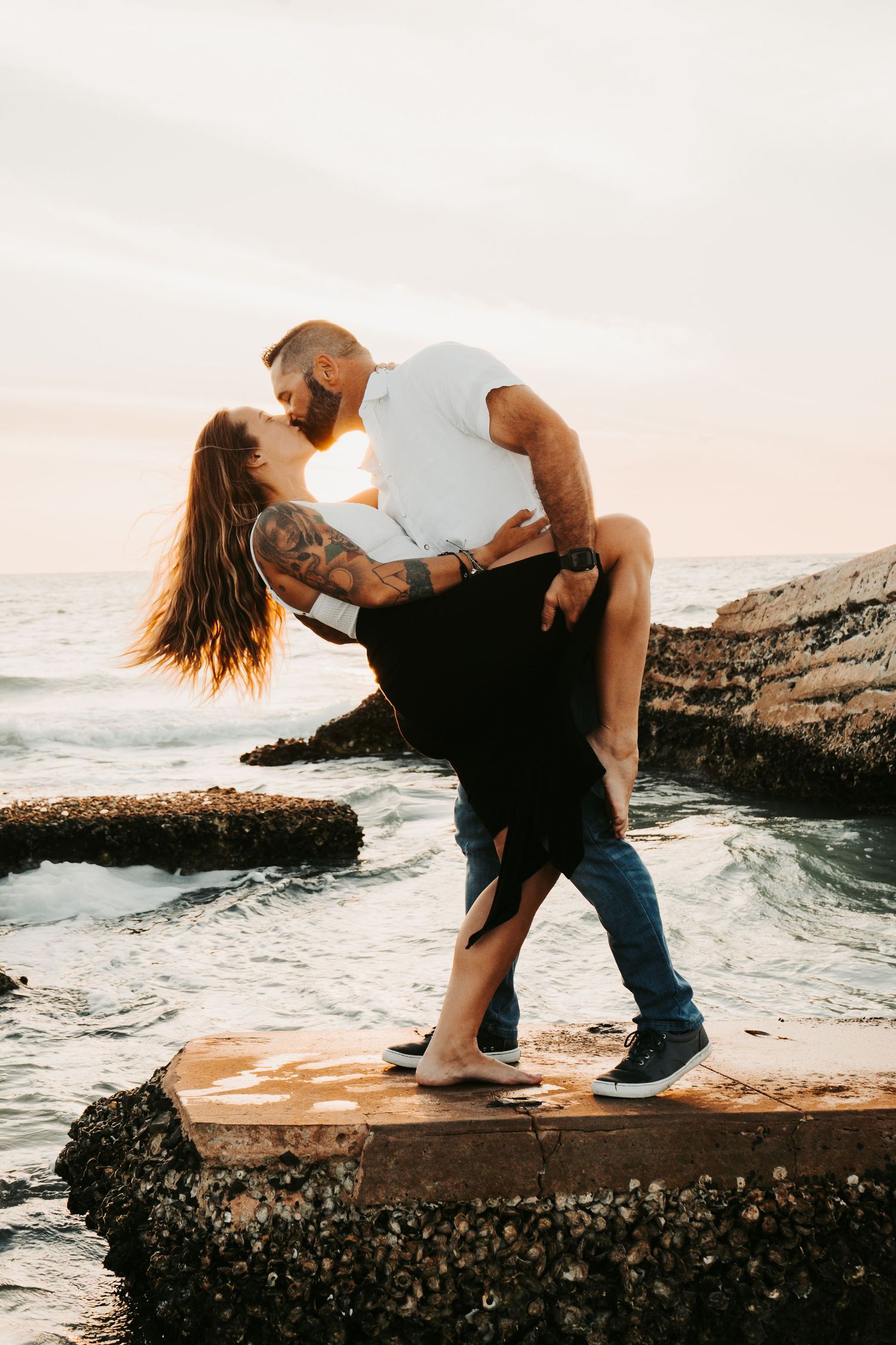 Outdoor Engagement Session Ft. Desoto, St. Pete, FL; Couple embracing at sunset