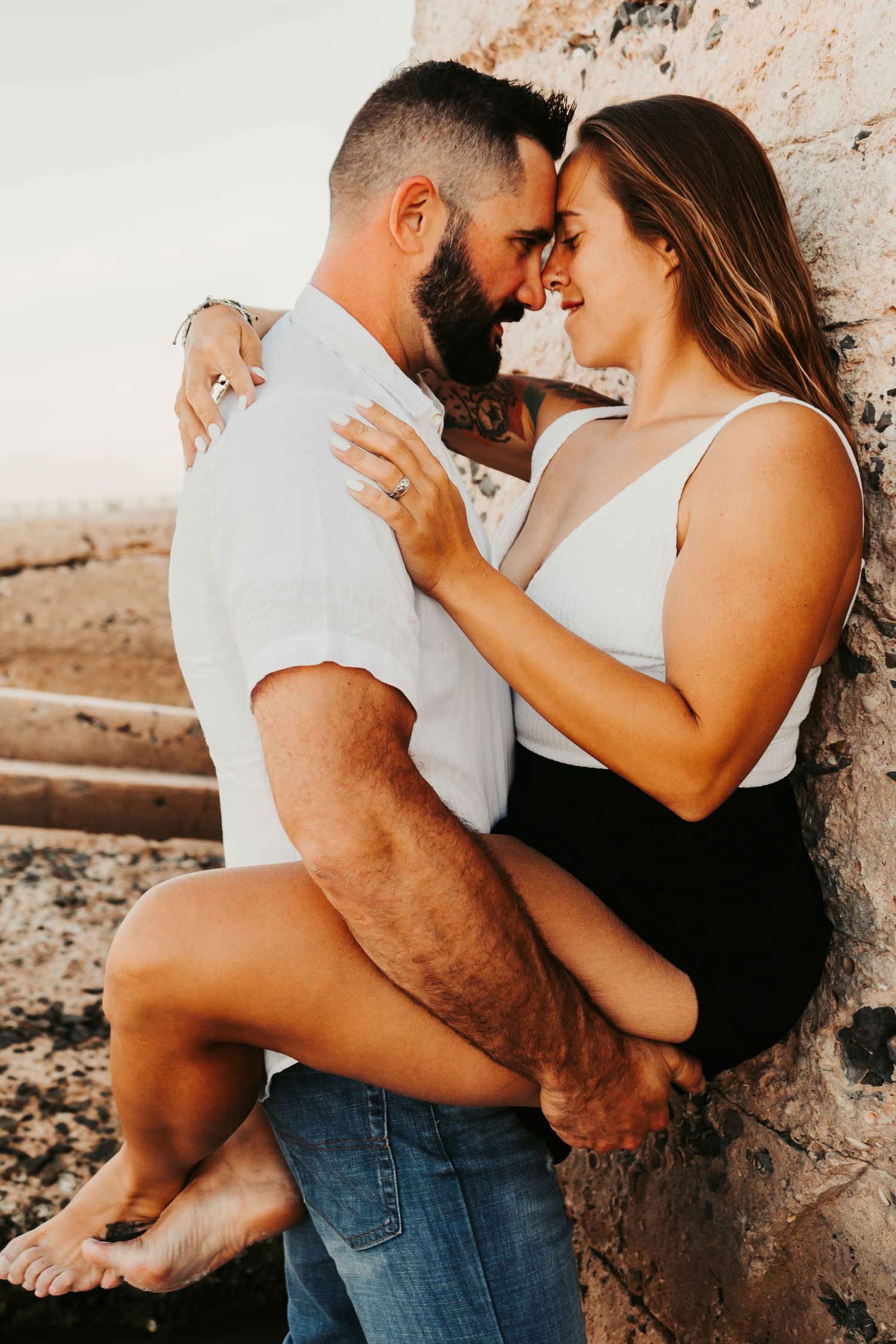 Outdoor Engagement Session Ft. Desoto, St. Pete, FL; Couple embracing at sunset