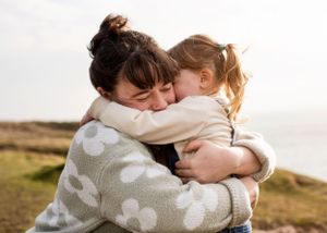 Intimate photograph of mother and daughter cuddling