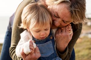 Photo of a grandmother embracing her grandaughter on south west coast