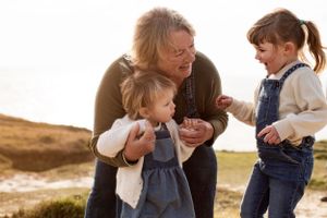 Fun family moment between a woman and her two granddaughters