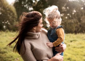 Atmospheric photo of mother and daughter with wind in their hair