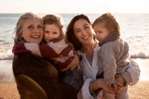 Extended family portait on the beach with three generations of women