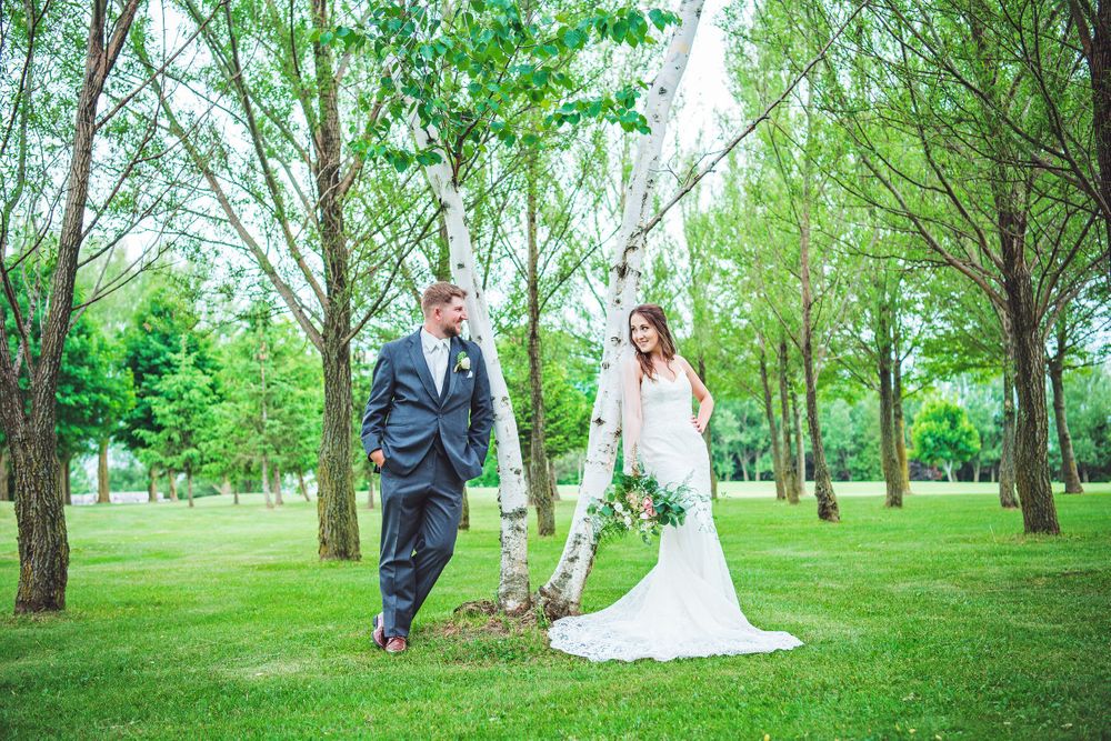 Panoramic wedding photography in a lush green spring forest setting.