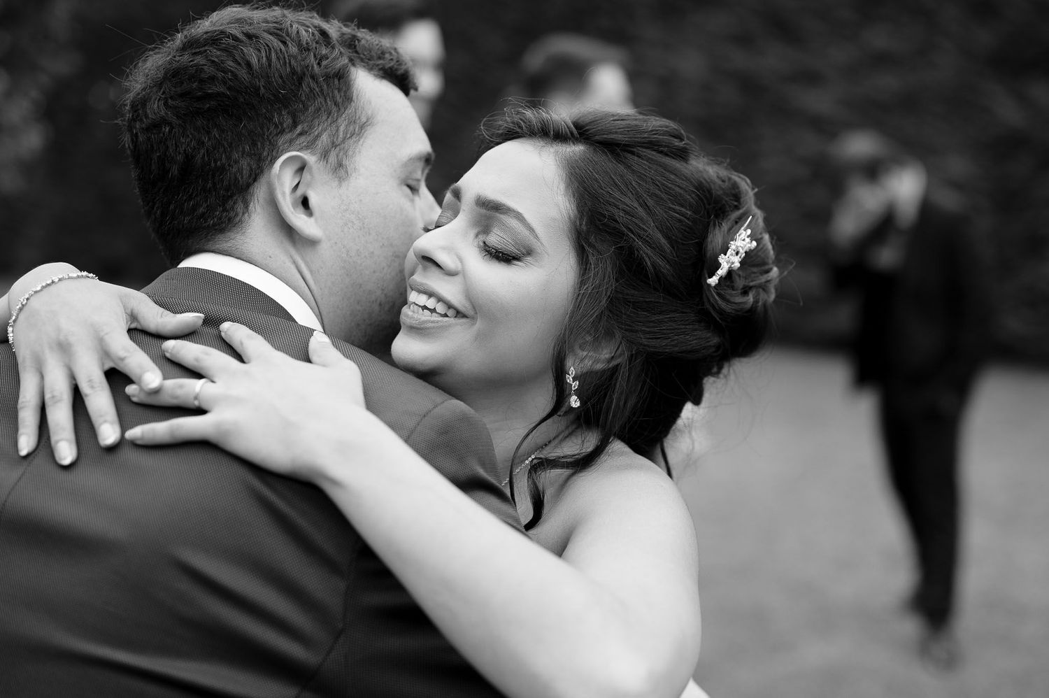 Intimate black and white portrait of newlyweds sharing a romantic moment during their first dance.