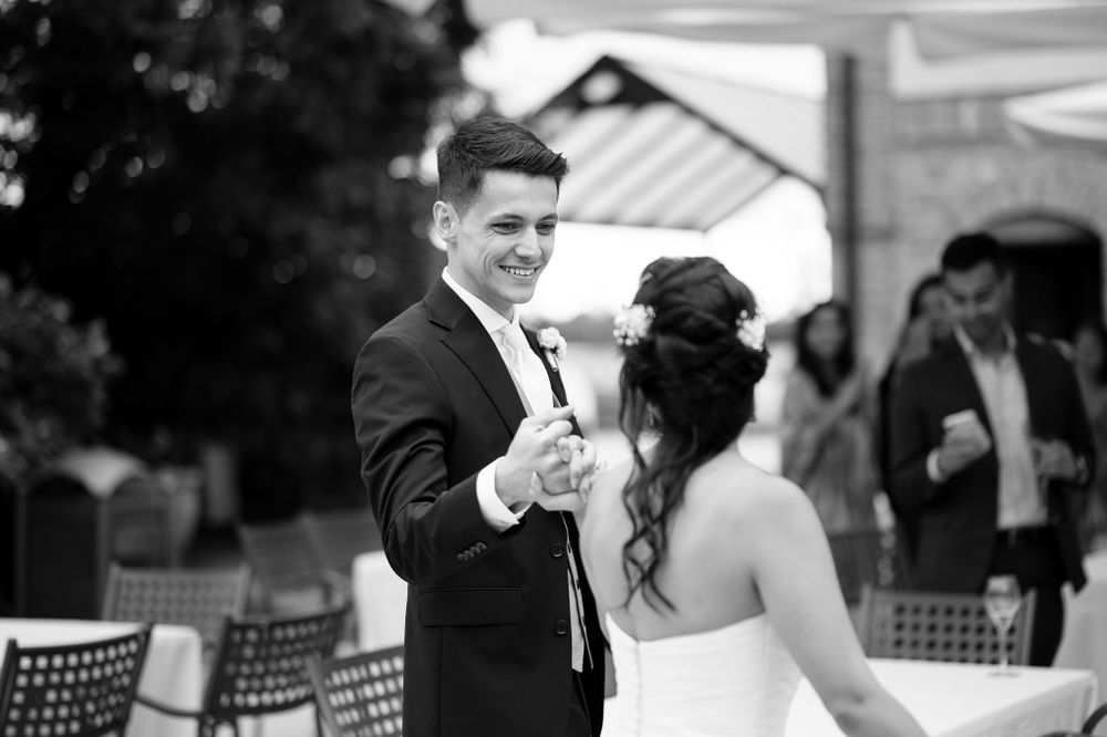 Black and white photo of a romantic first dance moment at an outdoor wedding reception.