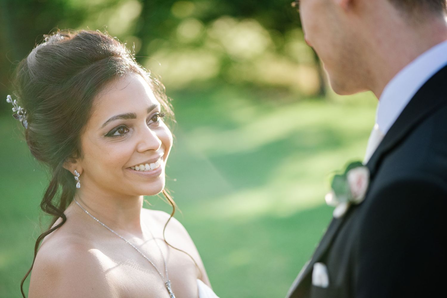 A romantic wedding portrait of a couple outdoors with soft natural lighting.